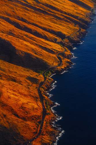iphone wallpapers aerial photography of road on mountain near seashore iphone backgrounds